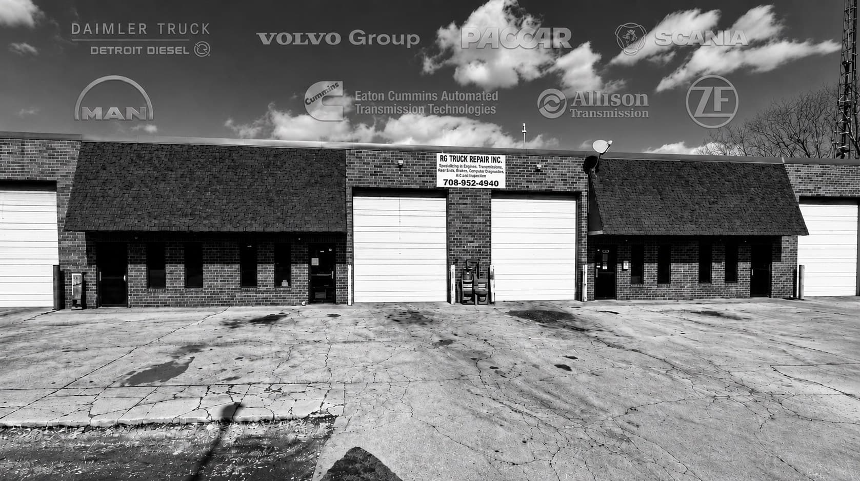 RG Truck Repair's shop on Kitty Ave — a brick building with four roll-up bay doors and a sign reading RG Truck Repair Inc, specializing in engines, transmissions, rear ends, brakes, computer diagnostics, A/C and inspection.